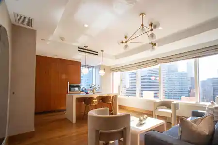 Ambassador suite living and kitchen area with city views at Concorde Hotel New York, bachata venue in New York