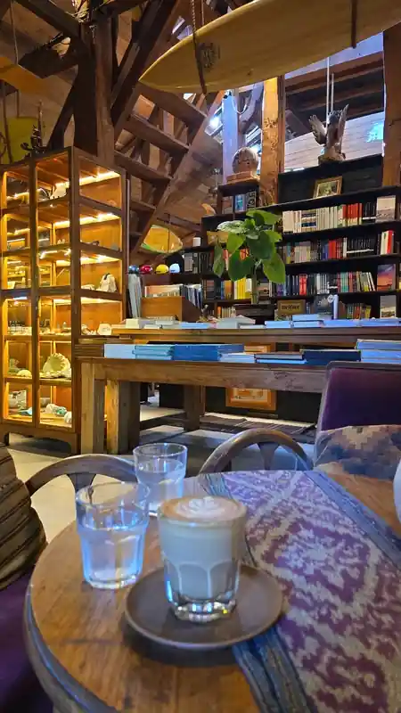 Cozy interior with bookshelves, surfboard ceiling, and wood architecture at Rolling Fork in Bali — salsa, bachata venue in Bali