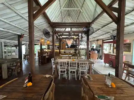 Wide view of the wooden pavilion dining hall and gelato cart at Rolling Fork in Bali — salsa, bachata venue in Bali