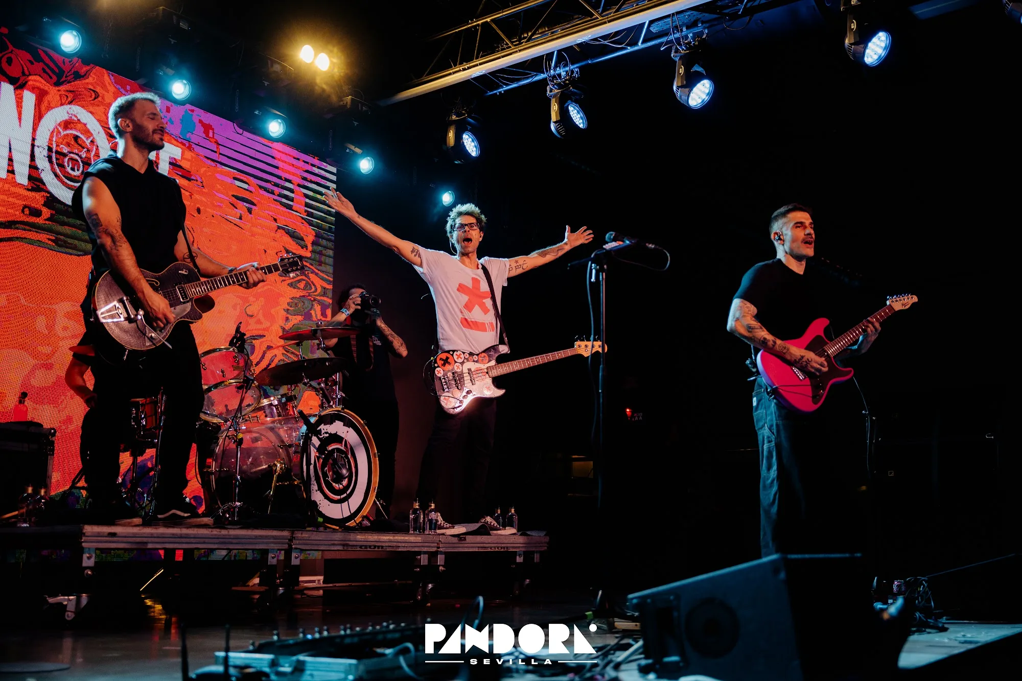 Live band on stage with Pandora Sevilla branding and crowd at Sala Pandora Seville