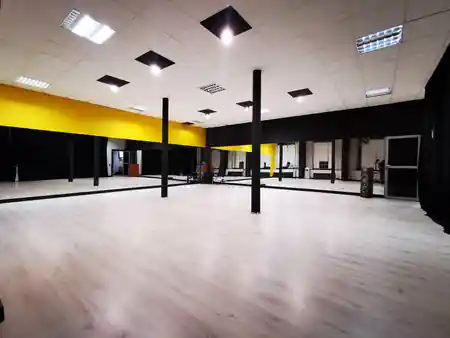 TONdance spacious main dance hall with mirrors, speakers, and yellow accent walls in Lodz — bachata, salsa, kizomba, zouk venue in Lodz