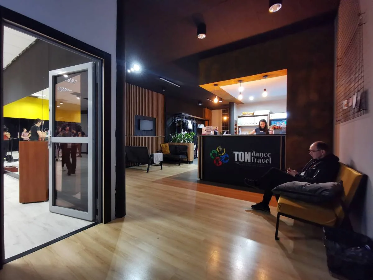 TONdance CAFE reception area and lobby with dance studio visible through glass wall in Lodz — bachata, salsa, kizomba, zouk venue in Lodz