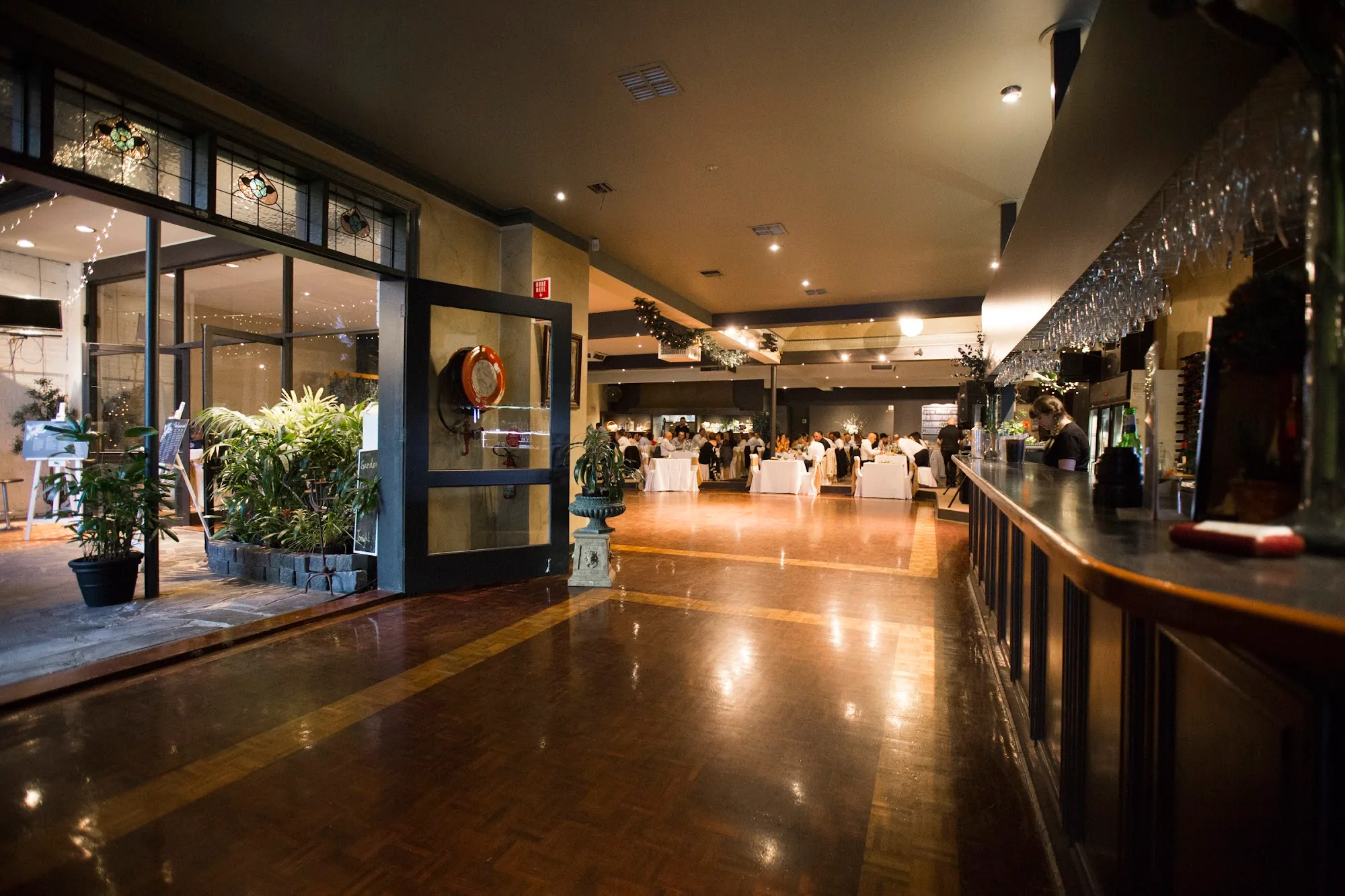 Polished wooden dance floor and bar inside The Aegean Restaurant in Melbourne