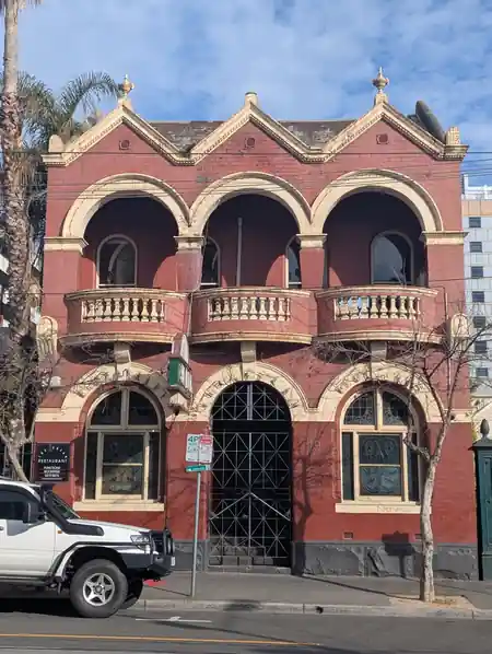 Heritage red-brick facade and signage of The Aegean Restaurant in Melbourne — kizomba venue in Melbourne