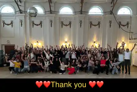 Group photo of salsa and bachata dancers inside Hammersmith Salsa & Bachata Club venue in London